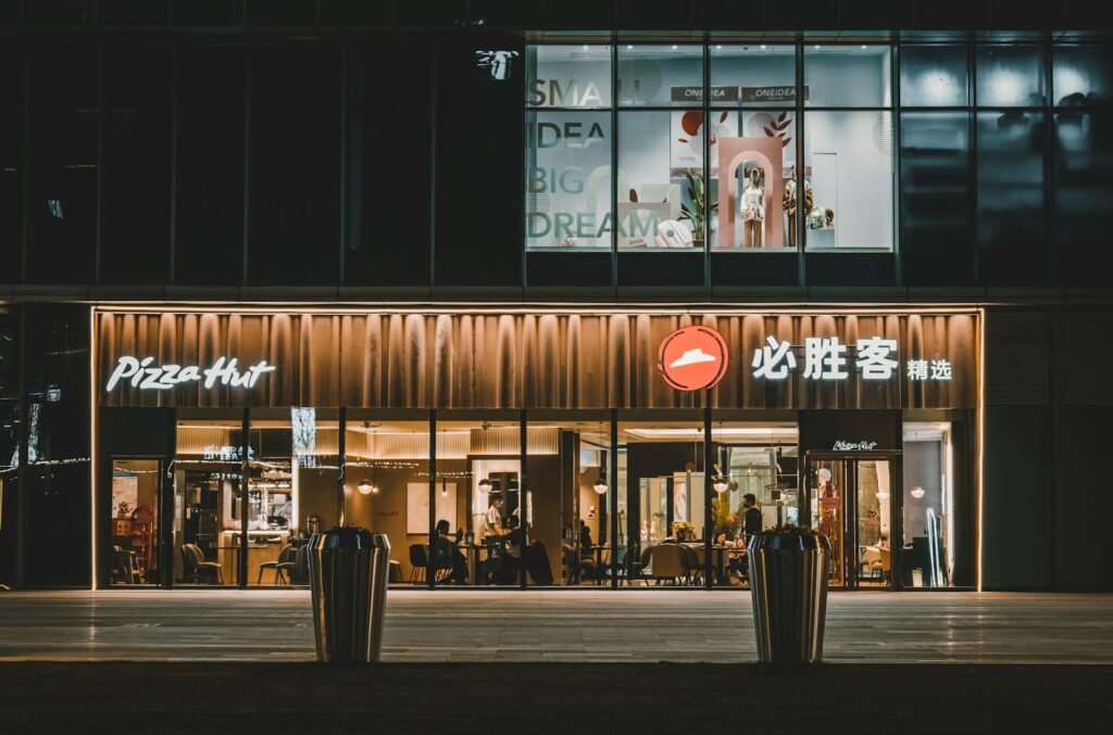 a building with a pizza hut lit up at night