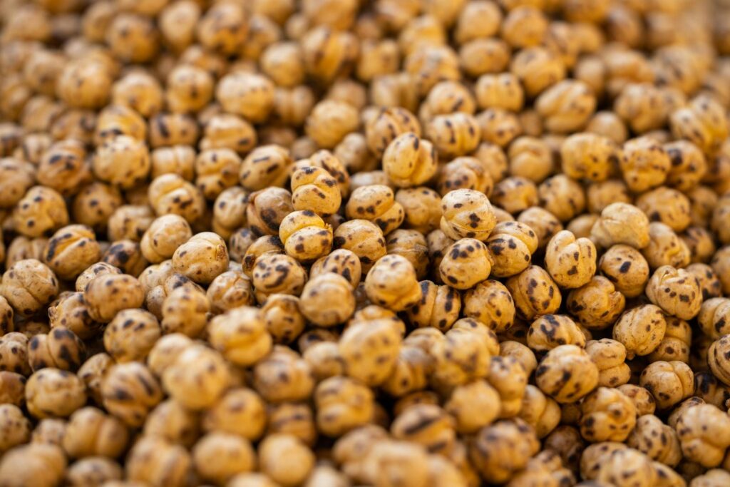 A direct view of roasted chickpeas showcasing their texture and vibrant color, perfect for culinary content.