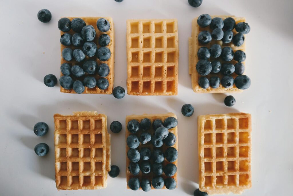 A tempting assortment of waffles topped with fresh blueberries, perfect for a healthy breakfast.