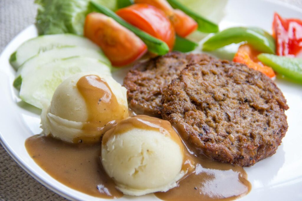 Delicious veggie patties served with mashed potatoes and fresh salad. Perfect for a wholesome meal.