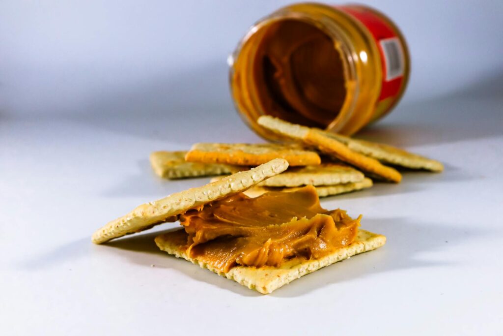 Delicious peanut butter spread on crispy crackers, perfect for a tasty snack.