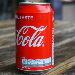 Coca-Cola can on brown wooden table