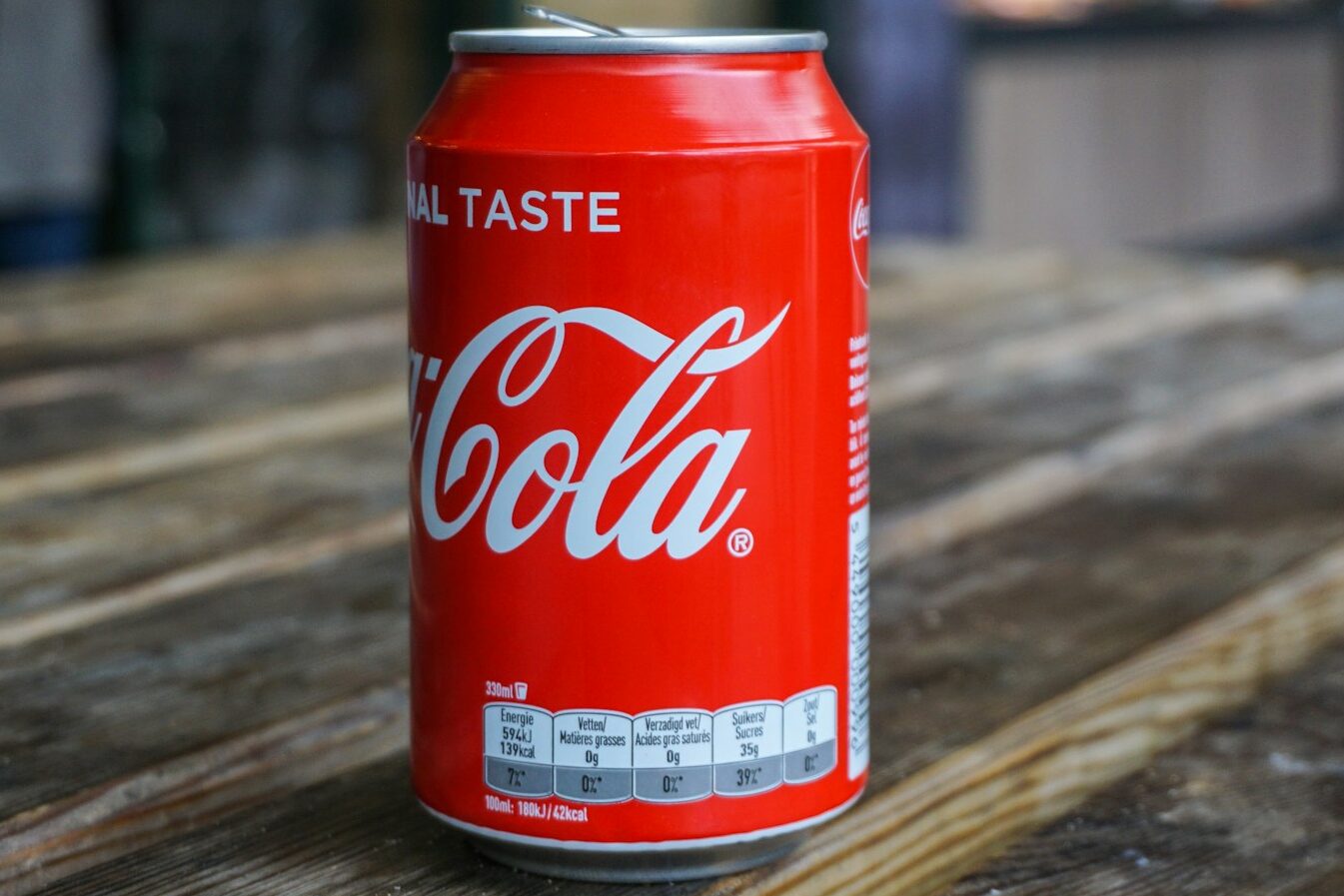 Coca-Cola can on brown wooden table
