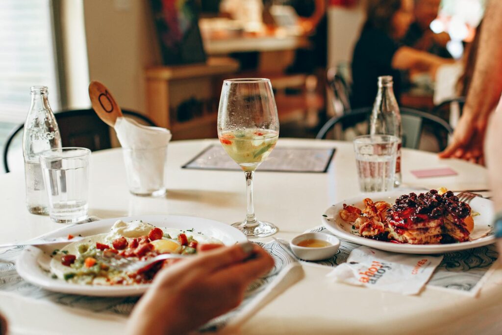 Delicious brunch featuring pancakes with berries and wine for a perfect dining experience.