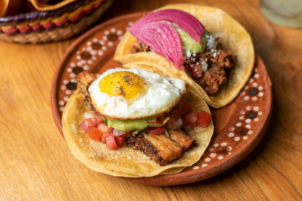 Close-up of flavorful Mexican tacos with toppings, served on a decorative plate in San Francisco.
