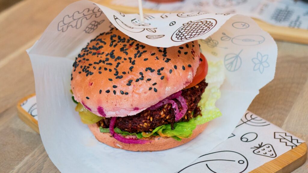 Delicious veggie burger with sesame bun, fresh lettuce, and tomatoes.