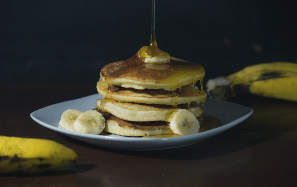 pancakes with syrup on white ceramic plate