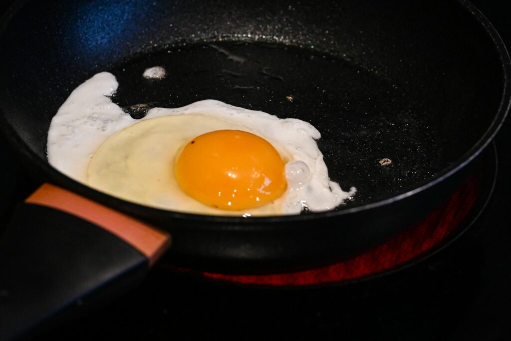 A fried egg in a frying pan on a stove