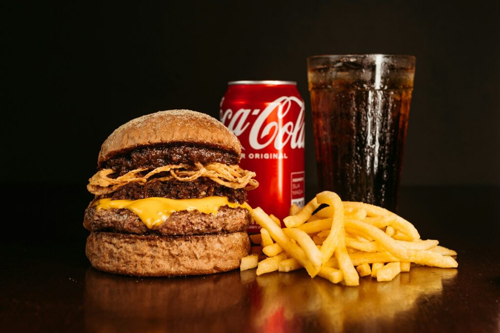 a hamburger, fries and a coke on a table
