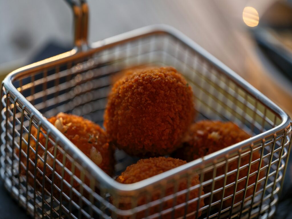 A basket filled with fried food sitting on top of a table