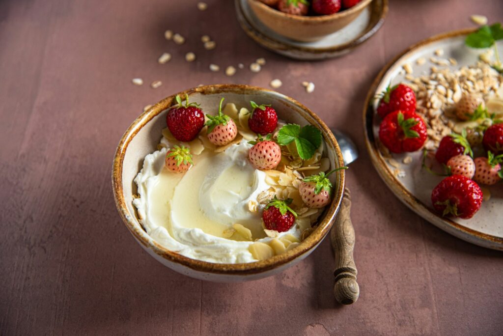 a bowl of yogurt with strawberries on top