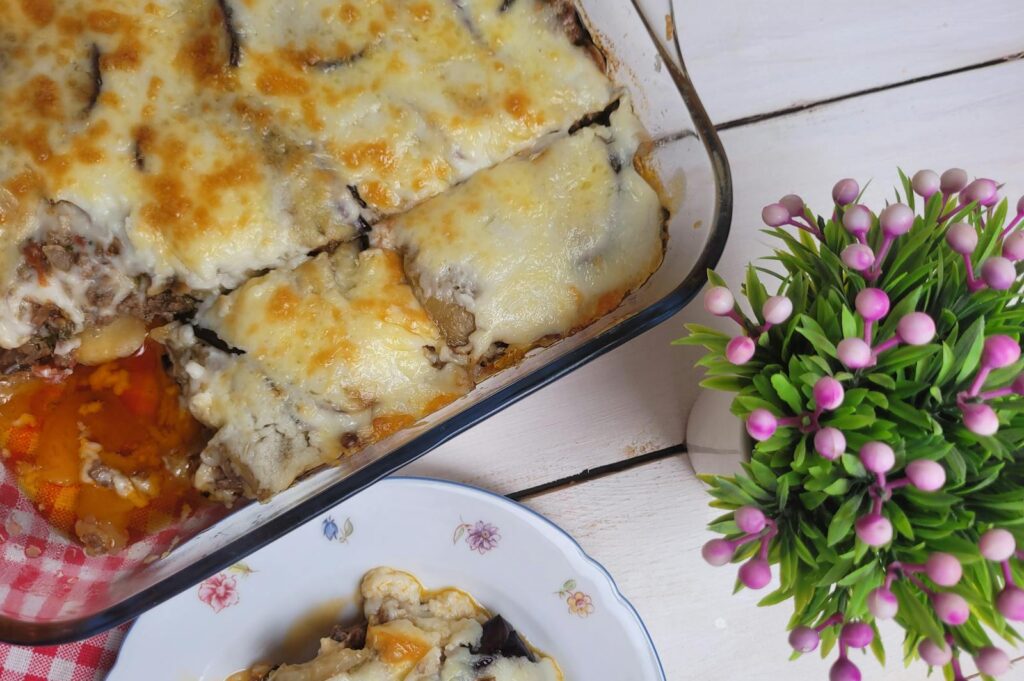 Top view of a cheesy baked moussaka served on a plate, perfect for food photography.