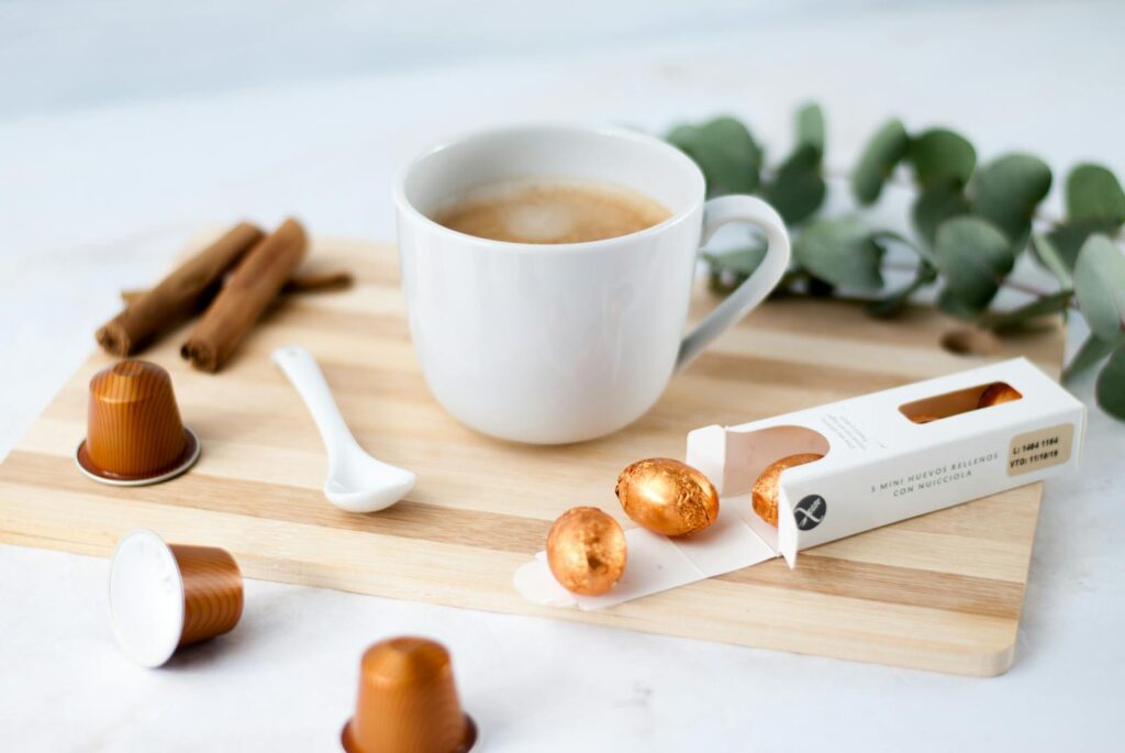 A relaxing coffee setup with chocolate eggs and cinnamon, perfect for Easter or cozy moments.