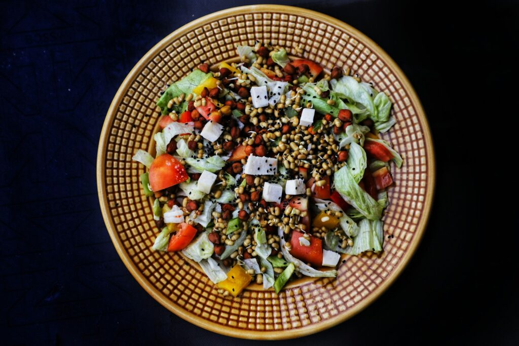 a bowl of salad with lettuce, tomatoes, cucumbers, and