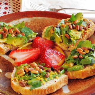 baked bread with sliced fruits on brown plate