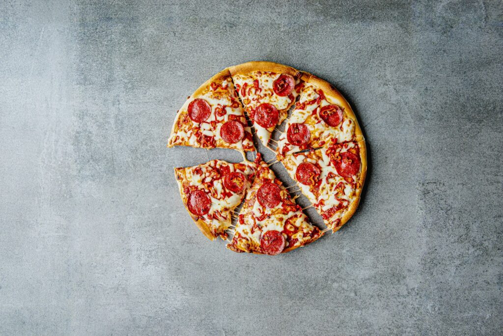 a pepperoni pizza with one slice missing