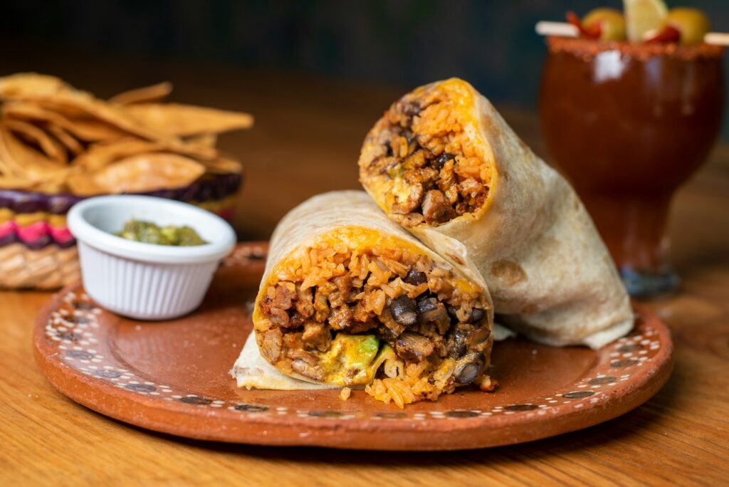 A burrito cut in half on a plate