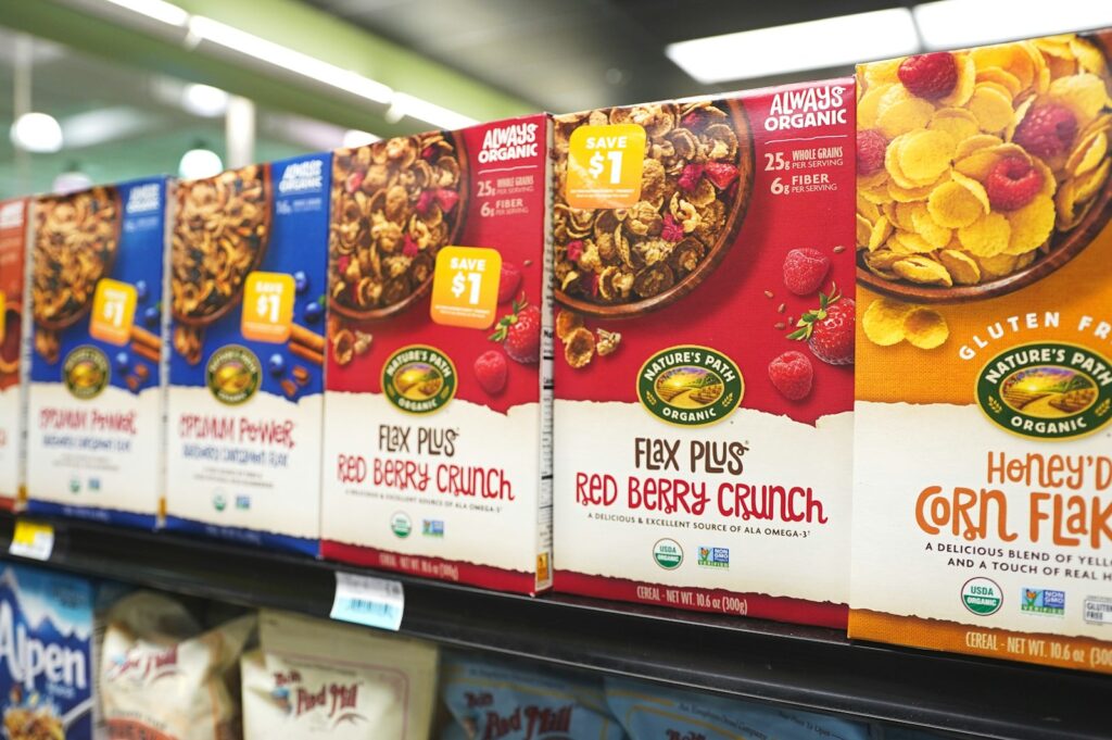A store shelf filled with cereal and cereal
