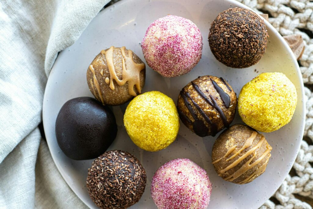 A white plate topped with different types of chocolates