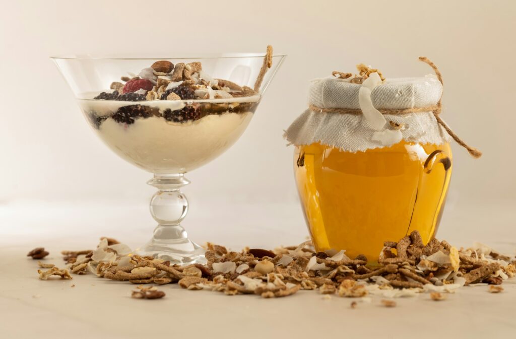 a glass of yogurt and a jar of granola