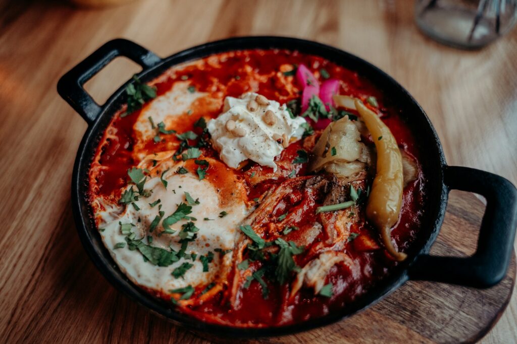 a pan filled with food on top of a wooden table